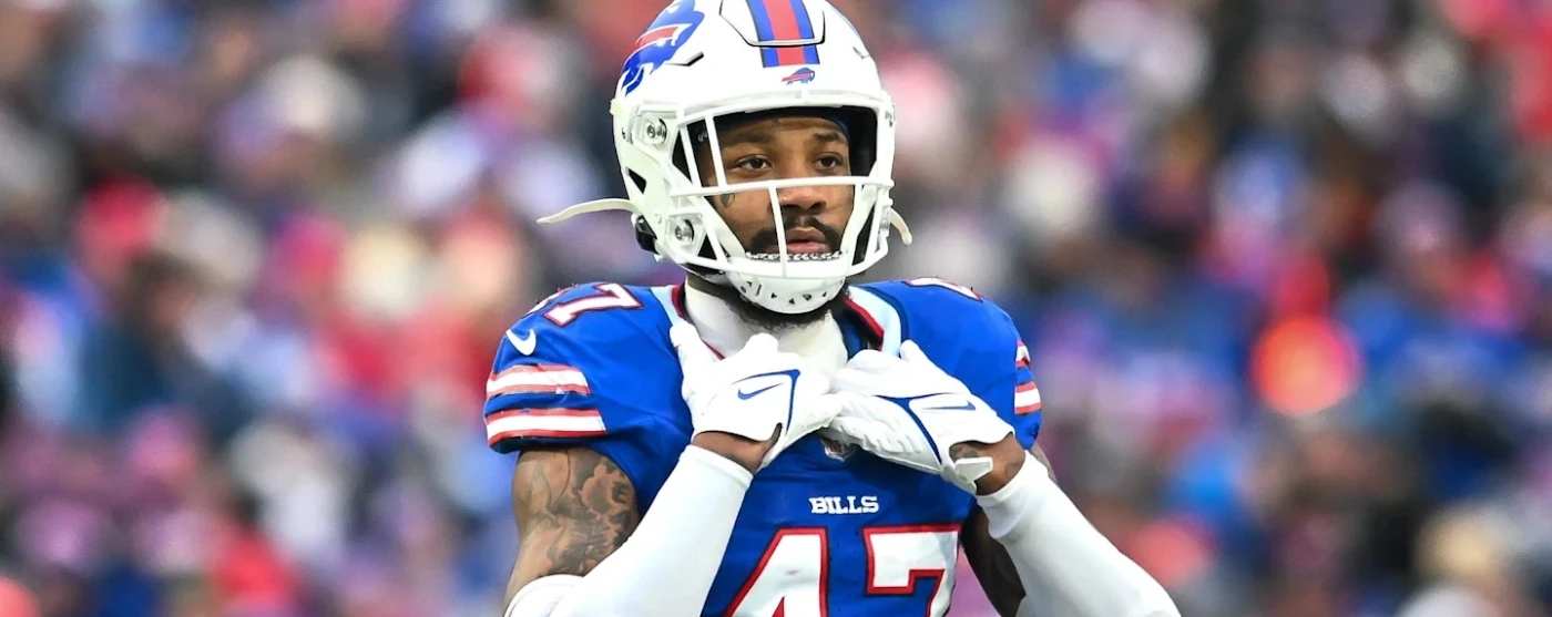 a football player holding his pads in front of his chest